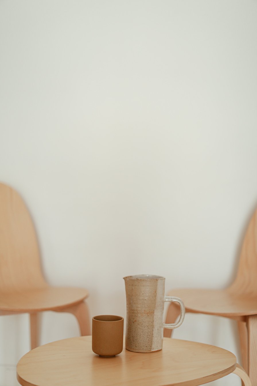 A Cup and a Mug on a Wooden Table